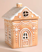 Decorative gingerbread house-shaped container on a beige background