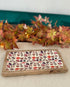 Decorative tray with leaf pattern on a table with autumn leaves in the background