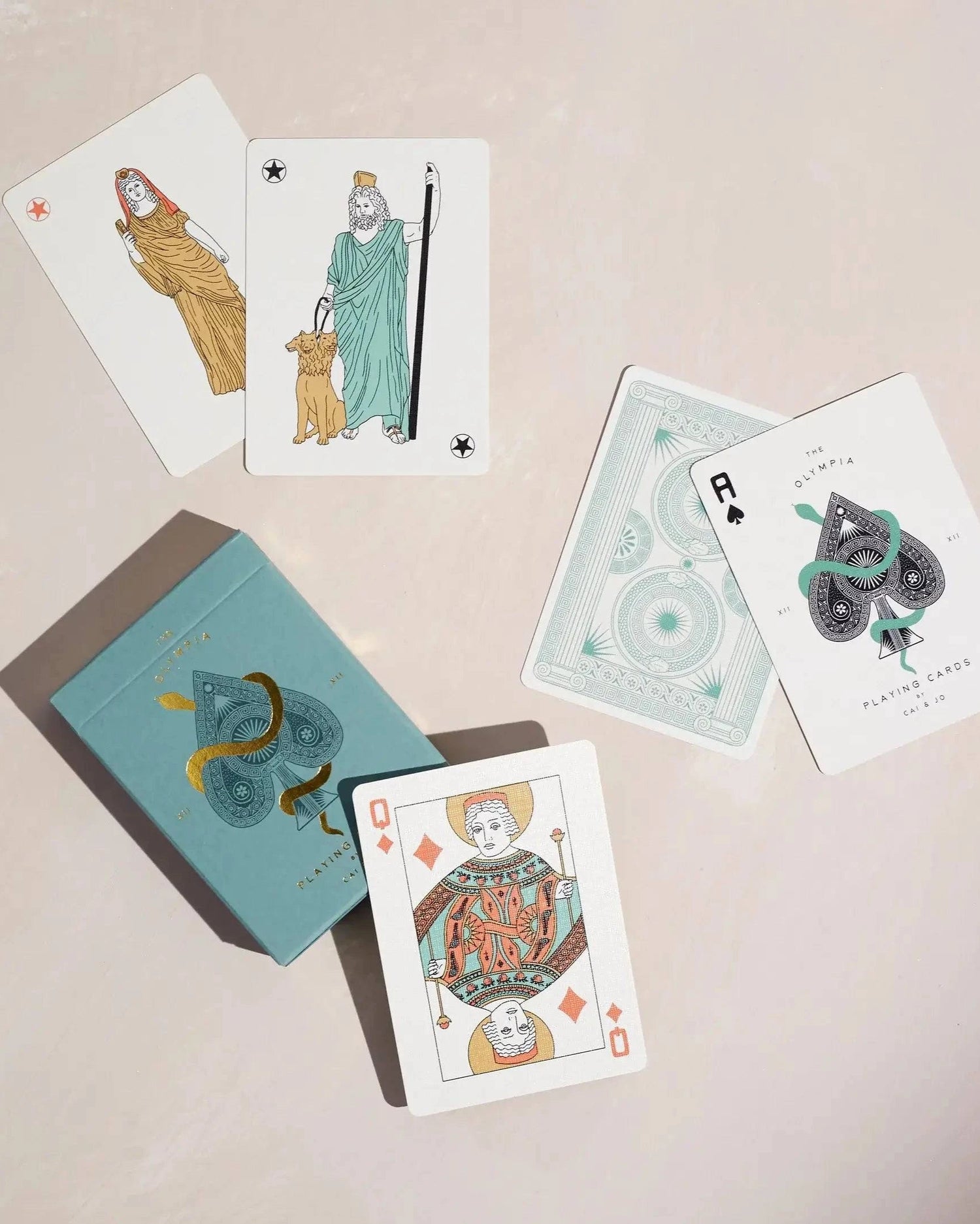 Top View of premium-grade playing cards in sage green with a gold-foiled tuck box featuring an ace of spades design with a snake wrapped around it. Ideal for games and gifting.