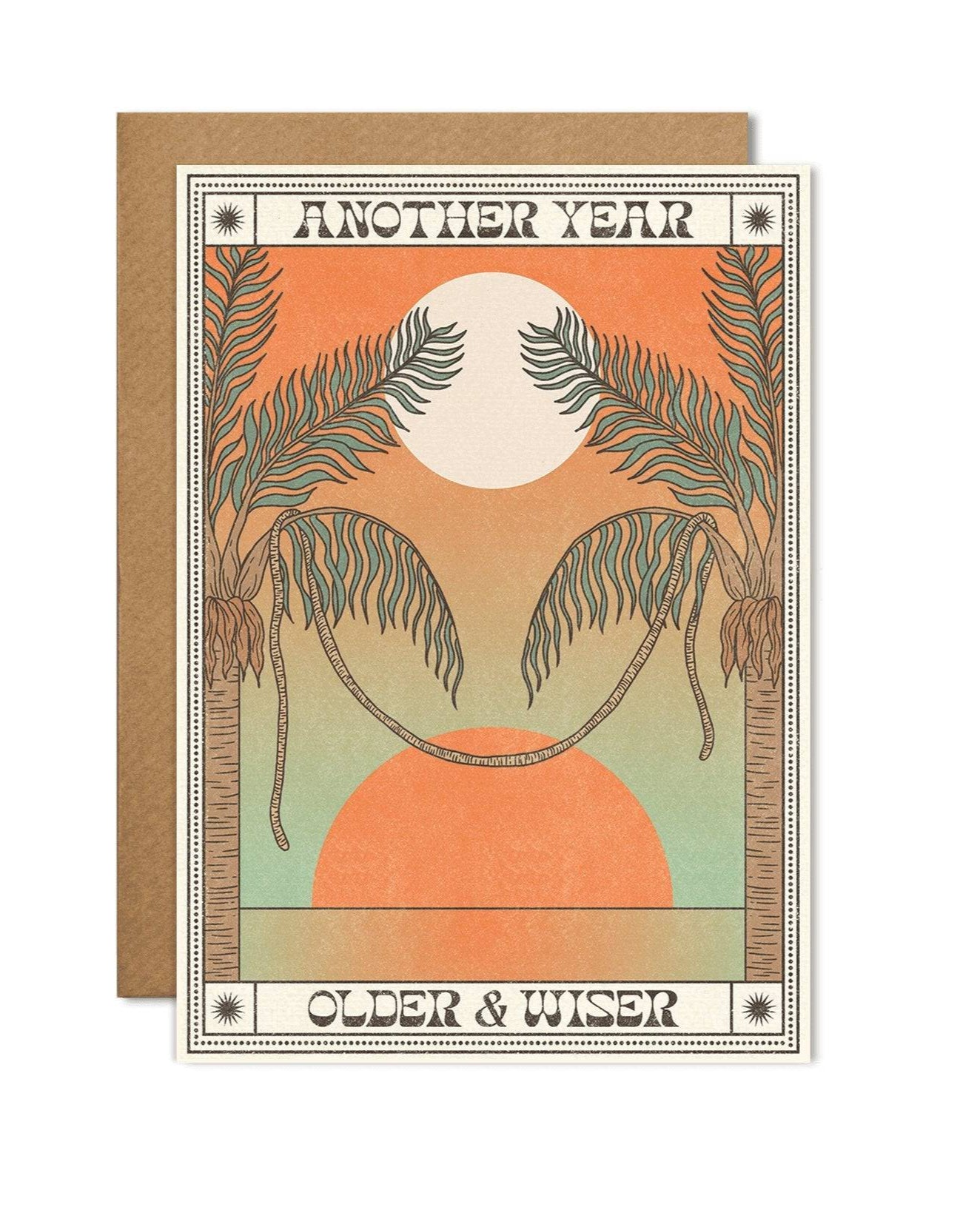 A6 eco-friendly birthday card with "Another Year Older & Wiser," featuring an orange sun and palm trees reminiscent of a sunset. Includes a Kraft envelope and biodegradable cello wrap.