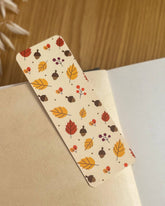 Autumn-themed waterproof bookmark featuring vibrant leaves in autumn colours, made from recycled tear-proof card stock with a velvet lamination. Perfect for book lovers.