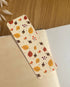 Autumn-themed waterproof bookmark featuring vibrant leaves in autumn colours, made from recycled tear-proof card stock with a velvet lamination. Perfect for book lovers.