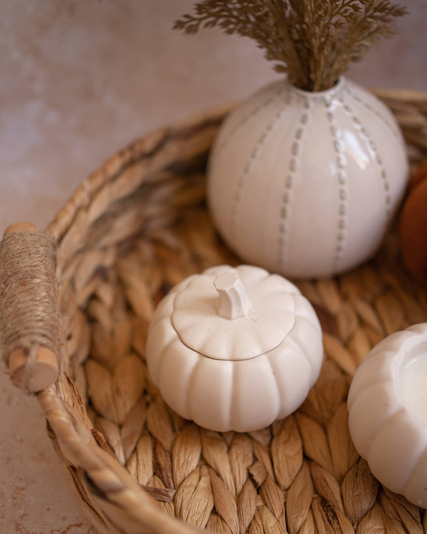 Decorative white pumpkins with textured surface in a woven basket