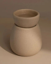 Back of Beige ceramic wax melt burner on a neutral table and background