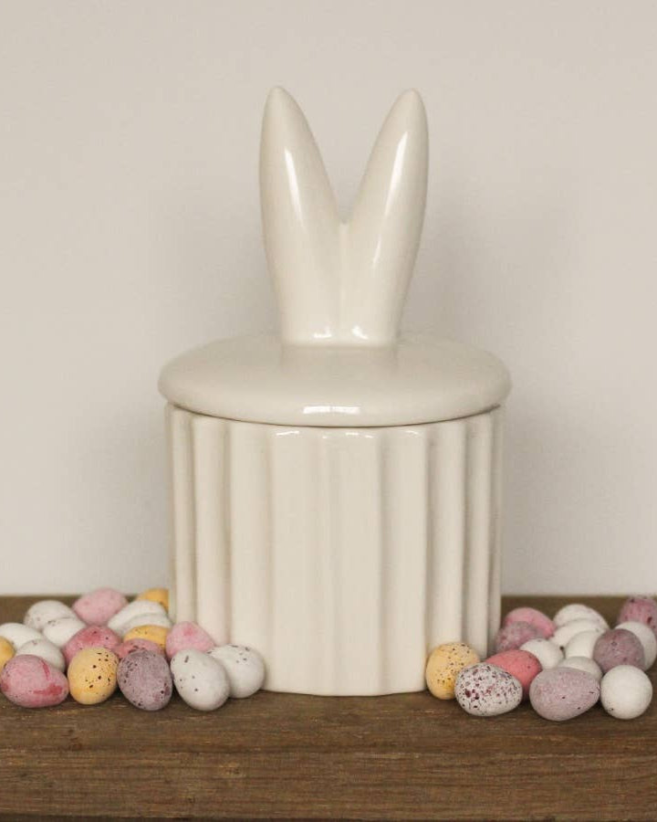 Ceramic storage pot featuring cute bunny ears. A delightful Easter décor piece.