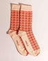 Orange socks with an all-over daisy flower pattern. Made from 75% cotton for a cosy fit, one size fits most.