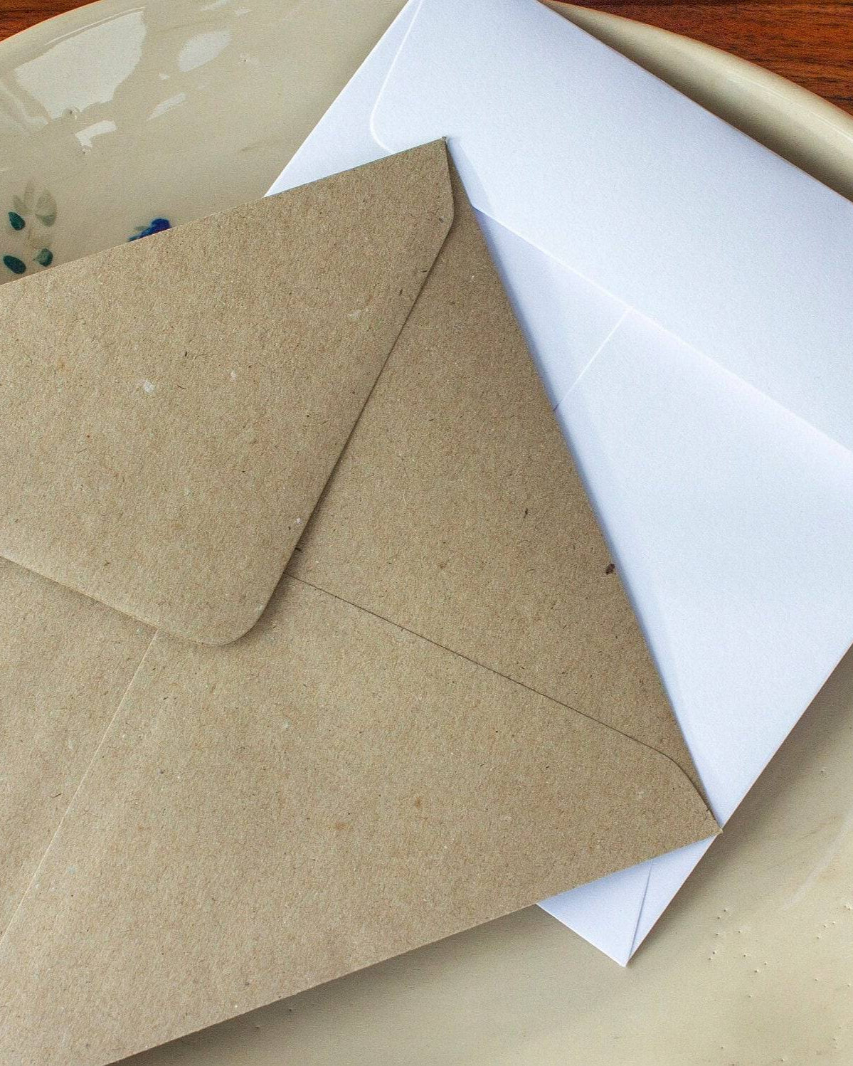 kraft and white envelopes in a dish