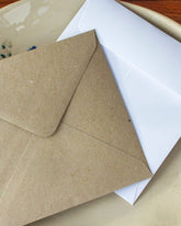 kraft and white envelopes in a dish