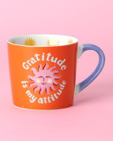 Cheerful new bone china mug with the phrase “Gratitude is My Attitude” and a sun illustration. Comes beautifully boxed in gold foiled packaging.