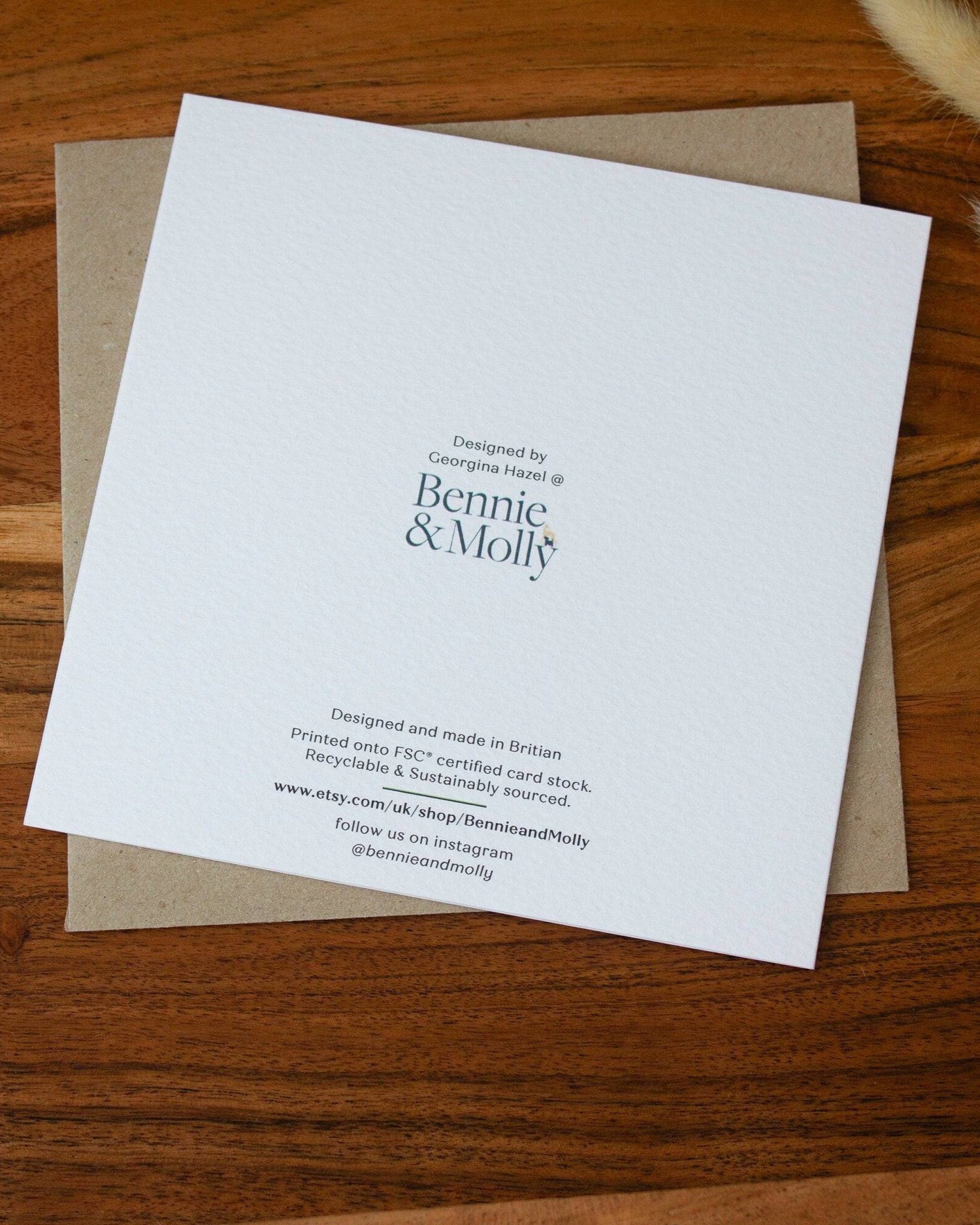 Handmade square greeting card with "You Are My Greatest Adventure" text, featuring a couple running up a mountain in line art with watercolour splashes. Eco-conscious and packaged with a Kraft envelope.