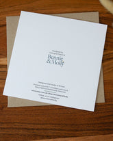 Handmade square greeting card with "You Are My Greatest Adventure" text, featuring a couple running up a mountain in line art with watercolour splashes. Eco-conscious and packaged with a Kraft envelope.