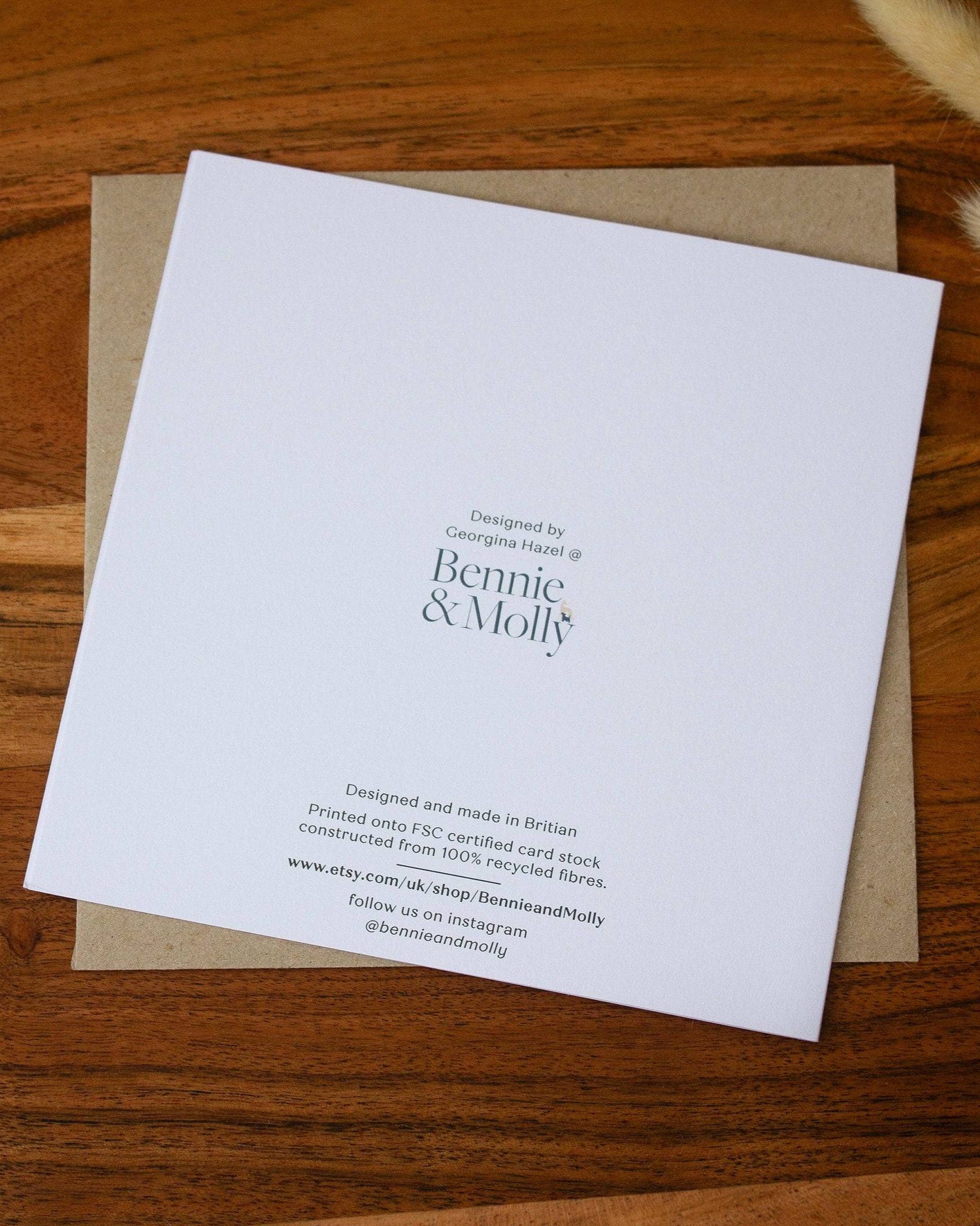 Handmade square birthday card featuring a bumblebee illustration with the words "Happy Bee-Day," printed on premium 100% recycled paper with a biodegradable cello wrap and Kraft envelope.