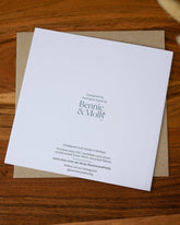 Handmade square birthday card featuring a bumblebee illustration with the words "Happy Bee-Day," printed on premium 100% recycled paper with a biodegradable cello wrap and Kraft envelope.