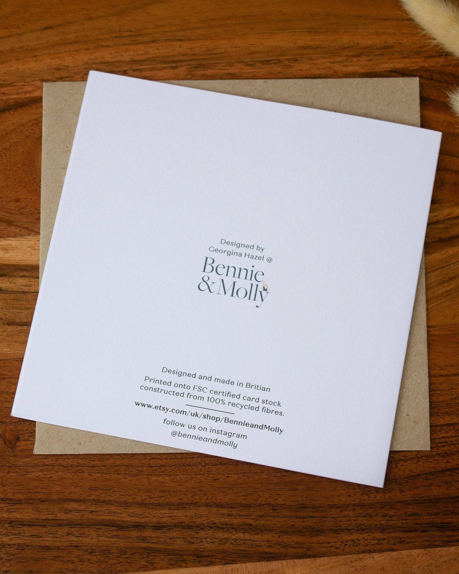 Handmade square birthday card featuring a bumblebee illustration with the words "Happy Bee-Day," printed on premium 100% recycled paper with a biodegradable cello wrap and Kraft envelope.