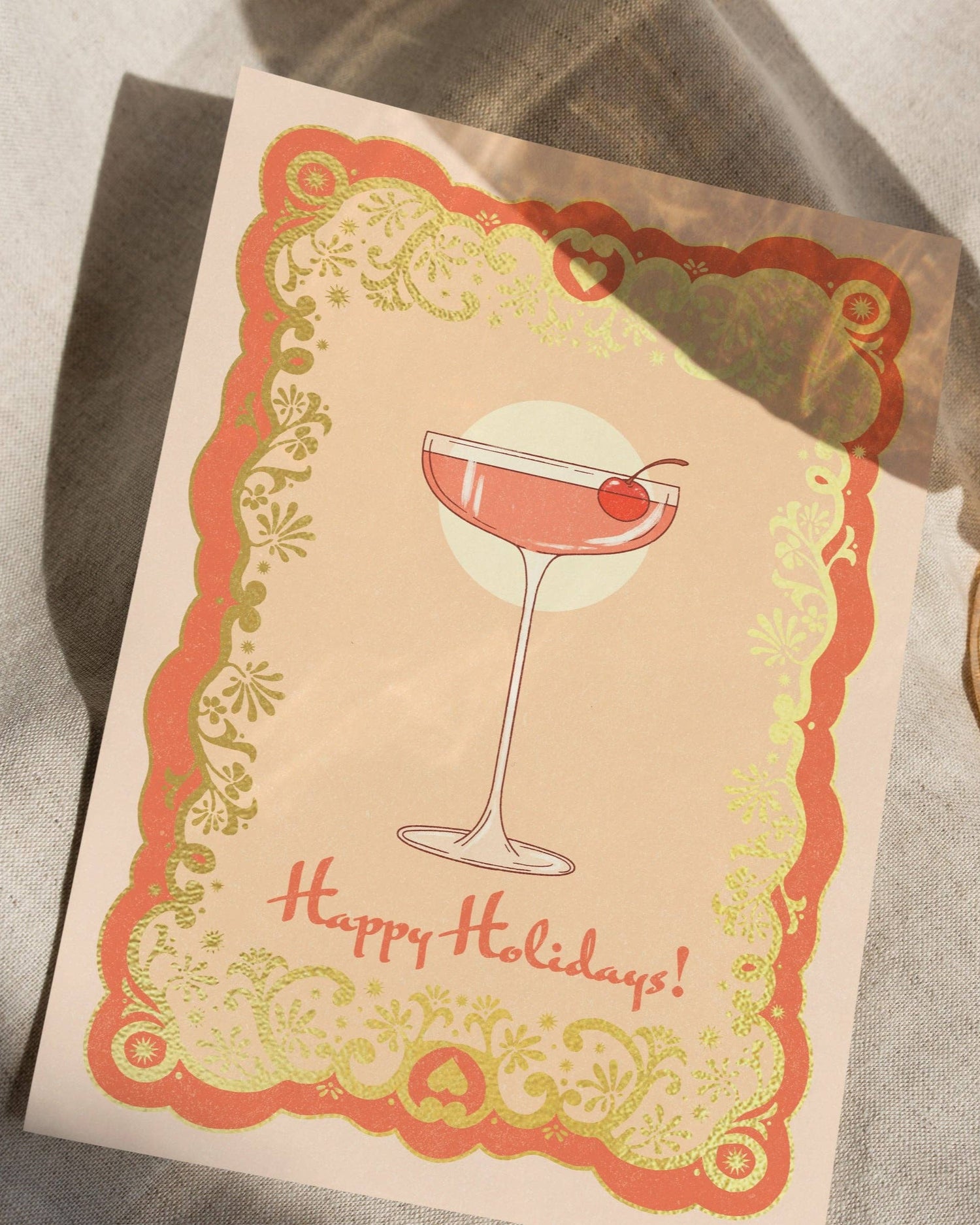 A6 handmade eco-conscious card in chic pink tones featuring a festive cocktail illustration with luxe gold foil. Includes a Kraft envelope and biodegradable cello wrap.