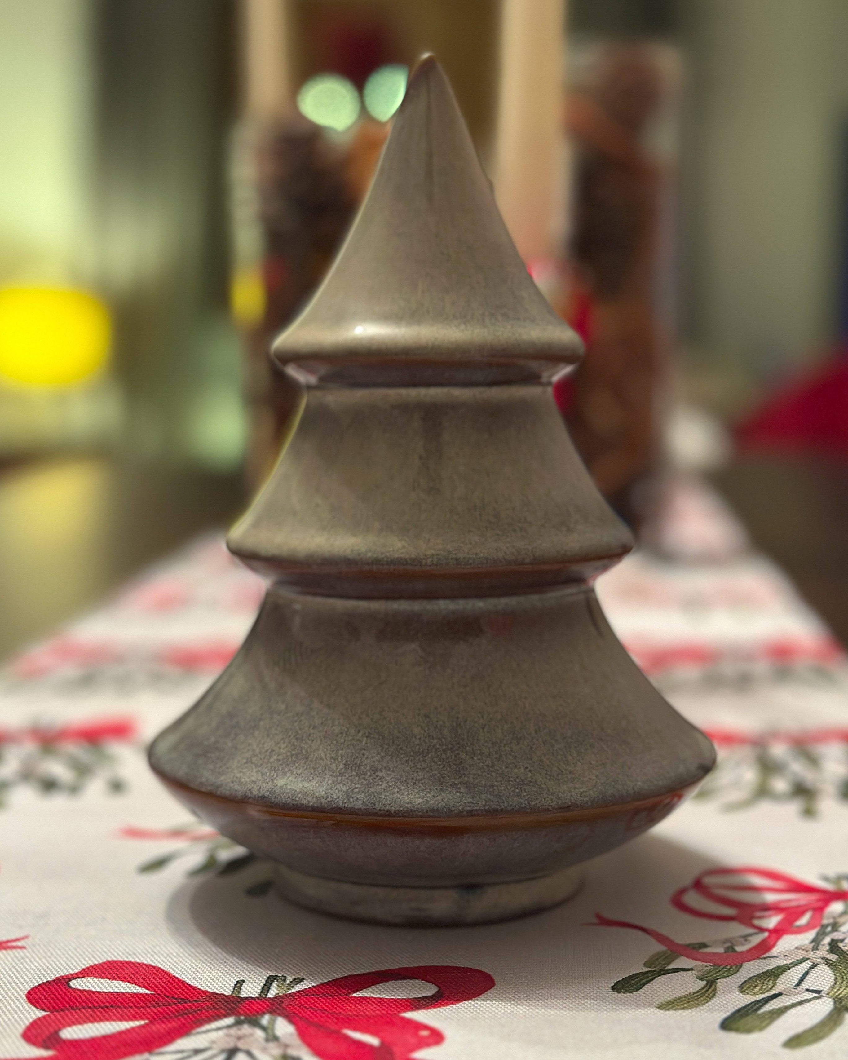 Porcelain Christmas tree ornament with a layered design and reactive glaze. Hand-finished and festive.