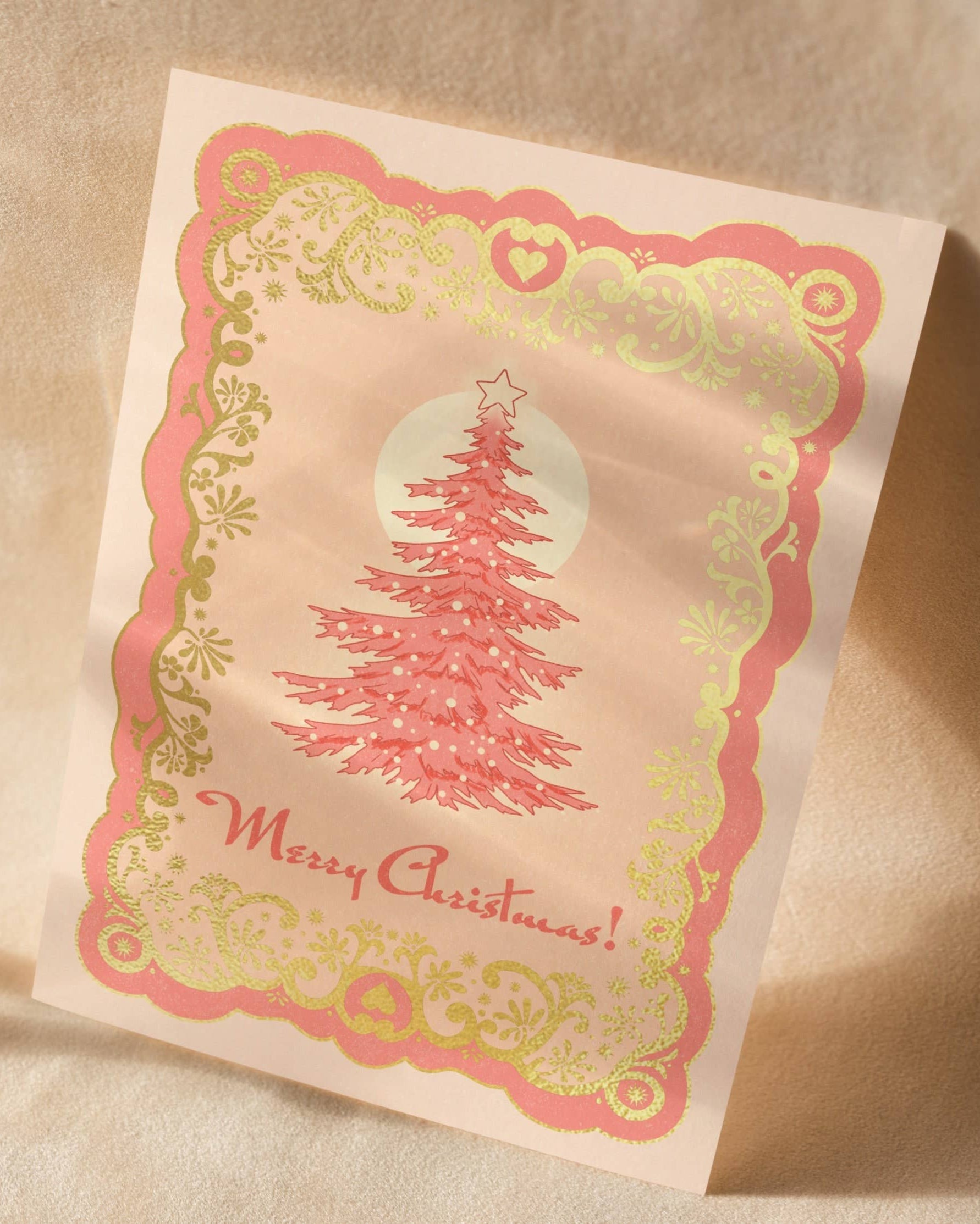 A6 handmade eco-conscious card with soft pink hues and luxe gold foil detailing, featuring a Christmas tree design. Includes a Kraft envelope and biodegradable cello wrap.