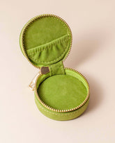Avocado green velvet polyester mini travel jewellery case with a zip closure and a sun embroidery. Perfect for travel and jewellery storage.