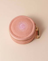 Dusty pink velvet polyester mini travel jewellery case with a zip closure and sun embroidery. Ideal for jewellery storage and travel.