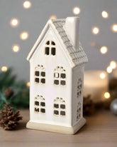 Hand-finished ceramic LED house with a textured roof and natural reactive glaze. Perfect for Christmas décor.