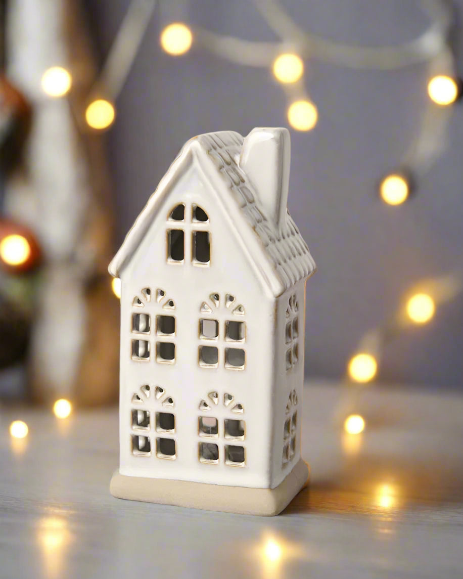 Hand-finished ceramic LED house with a textured roof and natural reactive glaze. Perfect for Christmas décor.