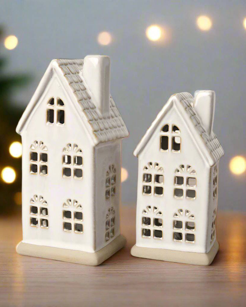Hand-finished ceramic LED house with a textured roof and natural reactive glaze. Perfect for Christmas décor.