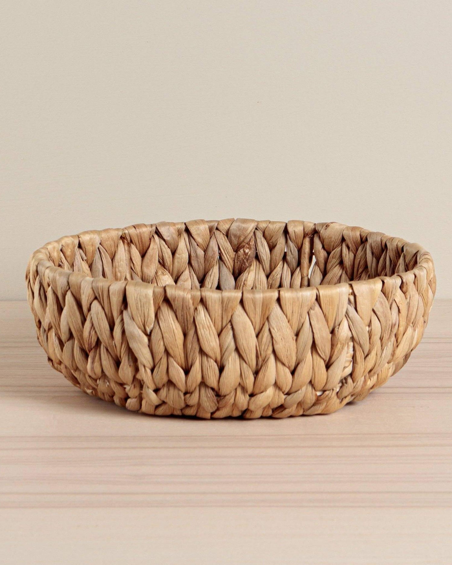 Handcrafted round bowl made from sustainable water hyacinth. A stunning eco-friendly home décor piece.