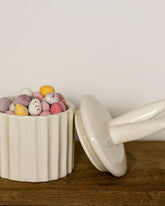 Ceramic storage pot featuring cute bunny ears. A delightful Easter décor piece.