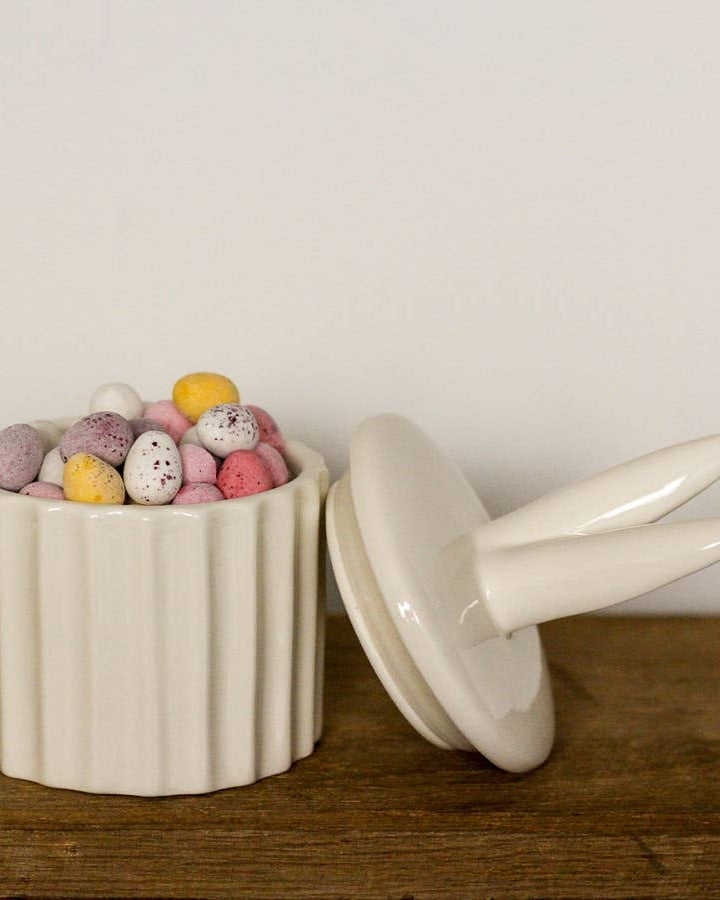 Ceramic storage pot featuring cute bunny ears. A delightful Easter décor piece.