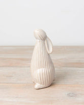 Standing ceramic bunny with a ribbed reactive glaze finish in white/cream. Ideal for Easter or spring décor.