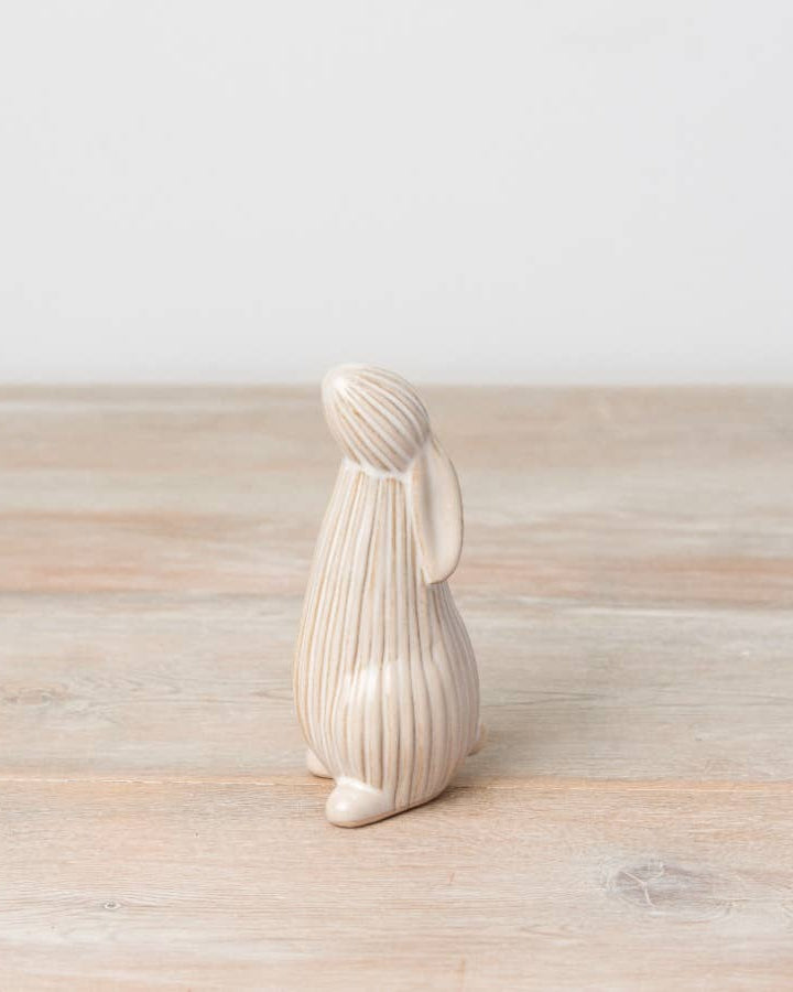 Standing ceramic bunny with a ribbed reactive glaze finish in white/cream. Ideal for Easter or spring décor.
