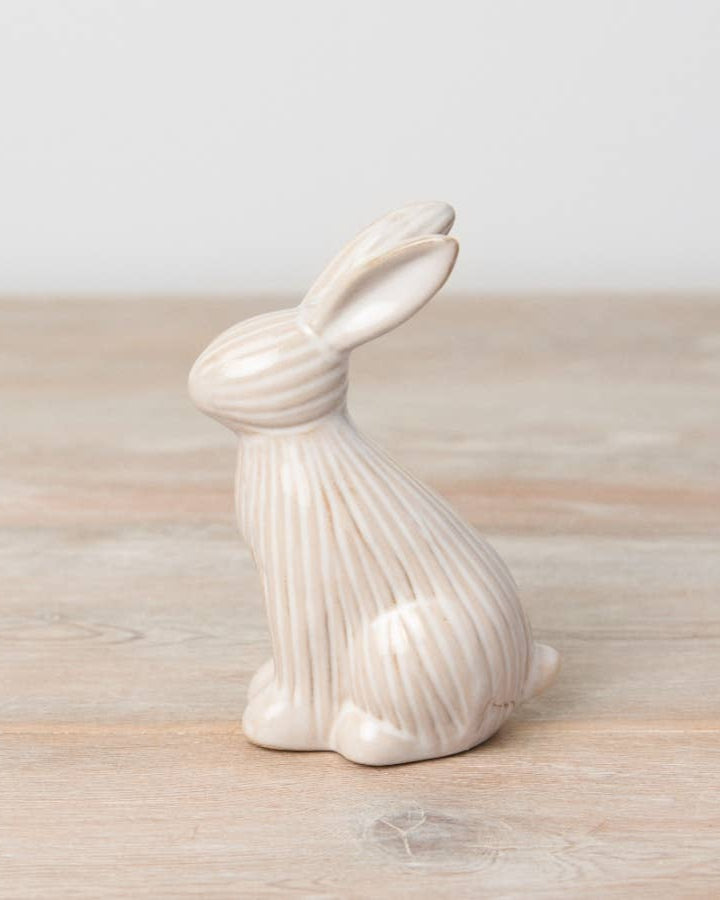 Sitting ceramic bunny with a ribbed reactive glaze finish in white/cream. A charming Easter or spring décor item.