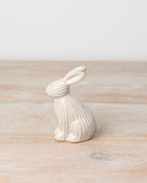 Sitting ceramic bunny with a ribbed reactive glaze finish in white/cream. A charming Easter or spring décor item.