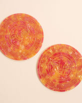 Set of two round handmade coasters in passionfruit pink acetate with engraved, gold-filled Sol face detail. Suitable for indoor or outdoor use. Perfect for home décor or barware.