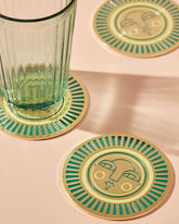 Round handmade teal coasters with gold-coloured metal and enamel, featuring the Sol face design. Perfect for home decor or barware.