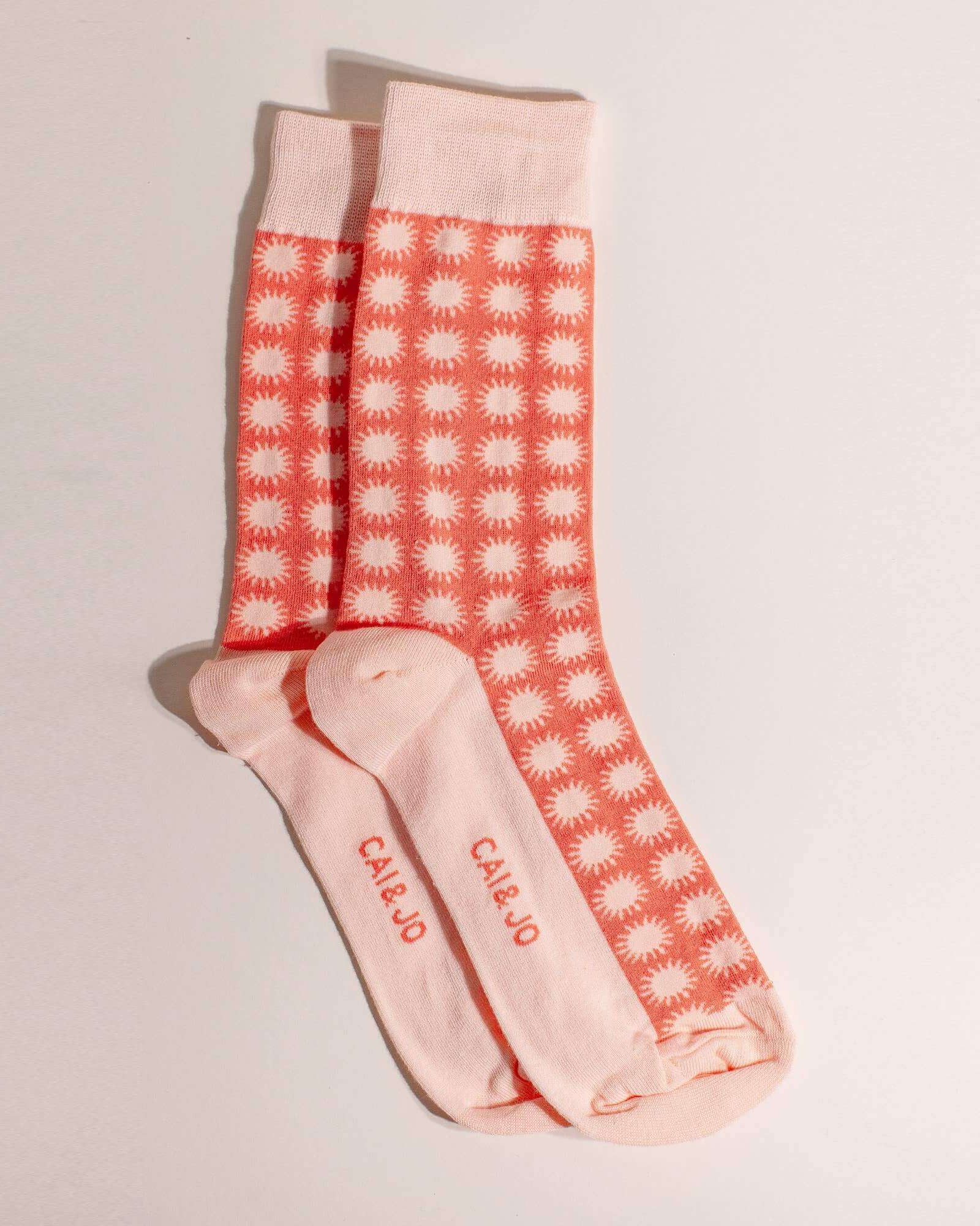 Orange socks featuring an all-over sunshine design. Made from 75% cotton for comfort, one size fits most.