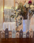Set of wooden Christmas houses adorned with blue and grey snow-effect designs. A charming festive décor piece.