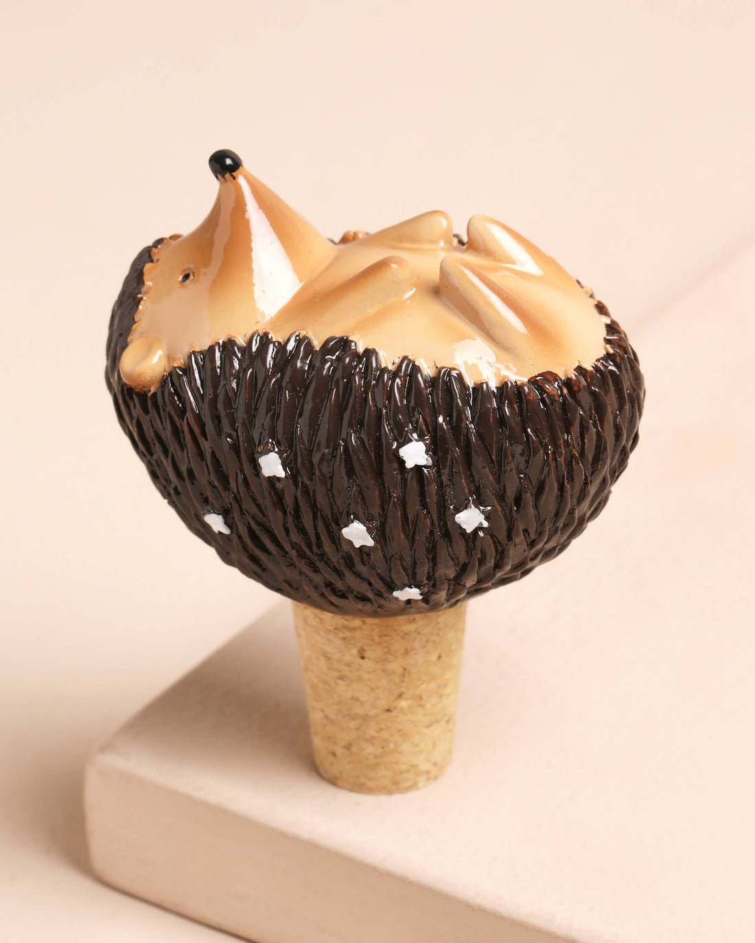 Decorative item resembling a stylized animal figure on a beige background