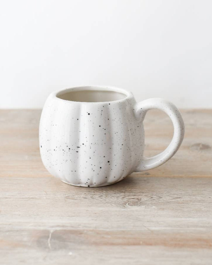Hand-finished ceramic pumpkin mug in speckled white. A charming addition to autumn-inspired collections.