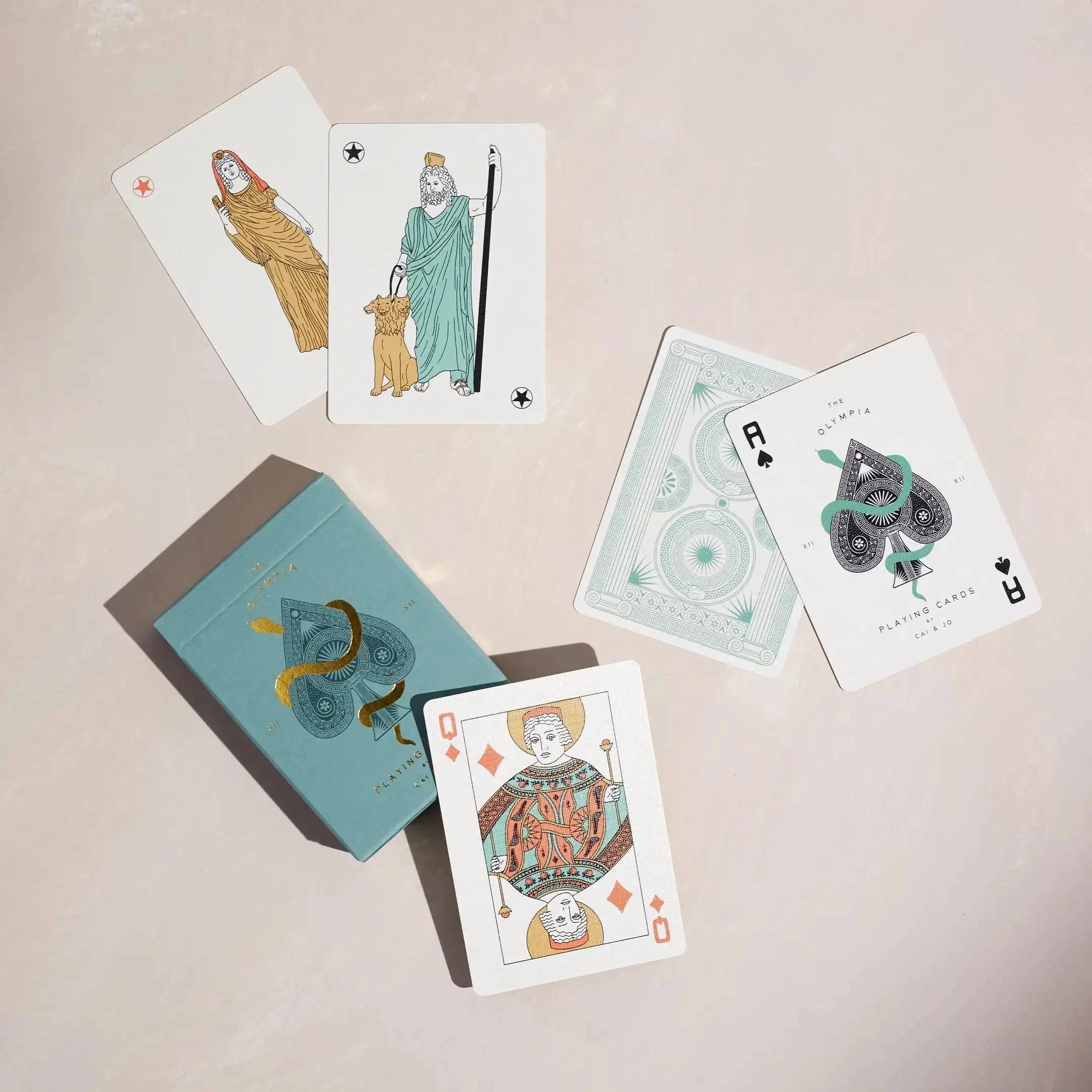 Top View of premium-grade playing cards in sage green with a gold-foiled tuck box featuring an ace of spades design with a snake wrapped around it. Ideal for games and gifting.