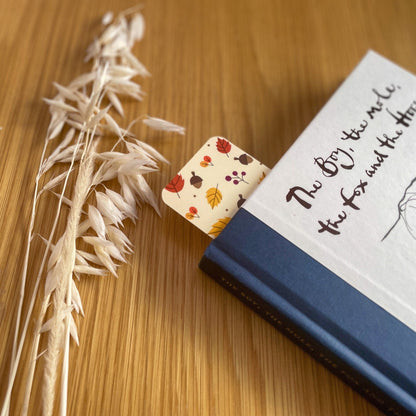 Autumn-themed waterproof bookmark featuring vibrant leaves in autumn colours, made from recycled tear-proof card stock with a velvet lamination. Perfect for book lovers.