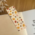 Autumn-themed waterproof bookmark featuring vibrant leaves in autumn colours, made from recycled tear-proof card stock with a velvet lamination. Perfect for book lovers.