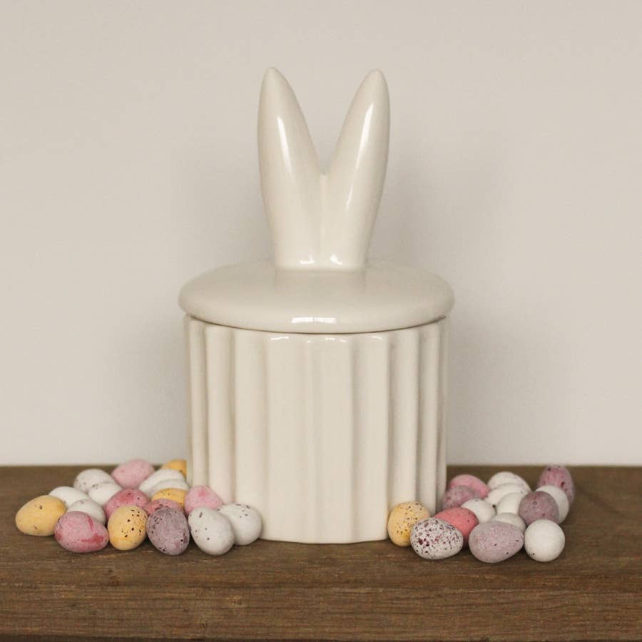 Ceramic storage pot featuring cute bunny ears. A delightful Easter décor piece.