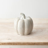 Reactive glazed cream ceramic pumpkin, hand-finished for a timeless autumn décor piece.