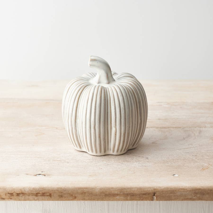 Reactive glazed cream ceramic pumpkin, hand-finished for a timeless autumn décor piece.