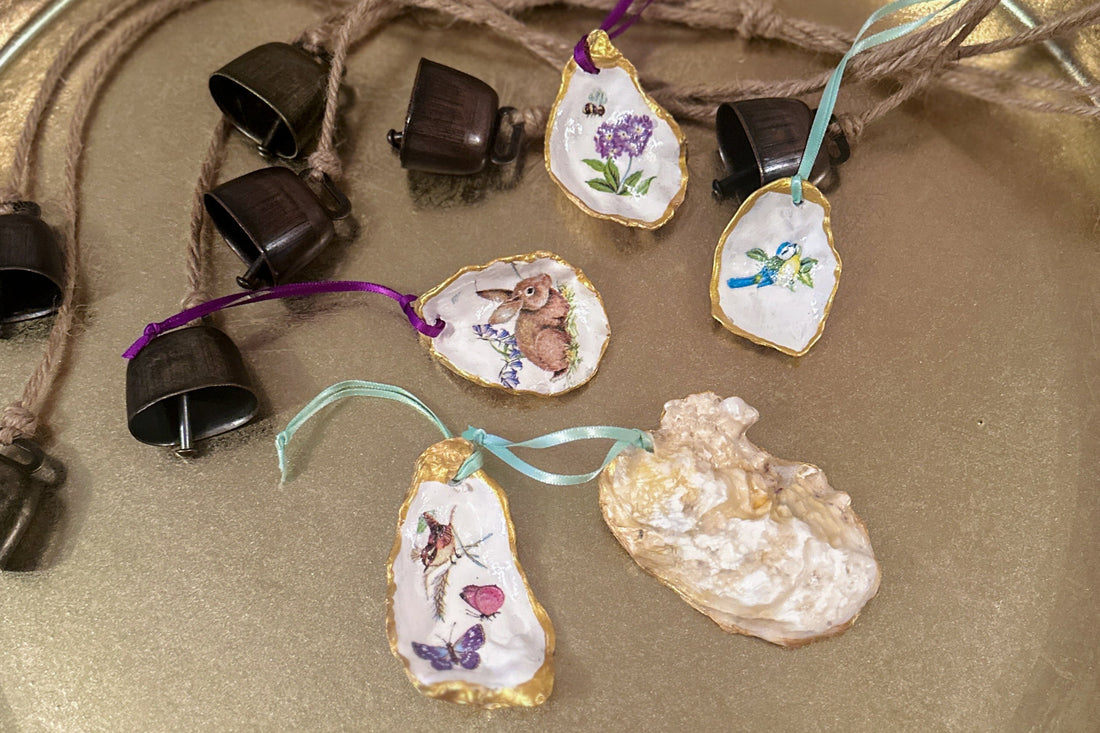 Set of five handmade Easter hanging ornaments crafted from oyster shells, various sizes, featuring a decoupage technique with hand-painted gold edges, decorated with spring motifs like bunnies, flowers, and bees, perfect for Easter or spring decor.