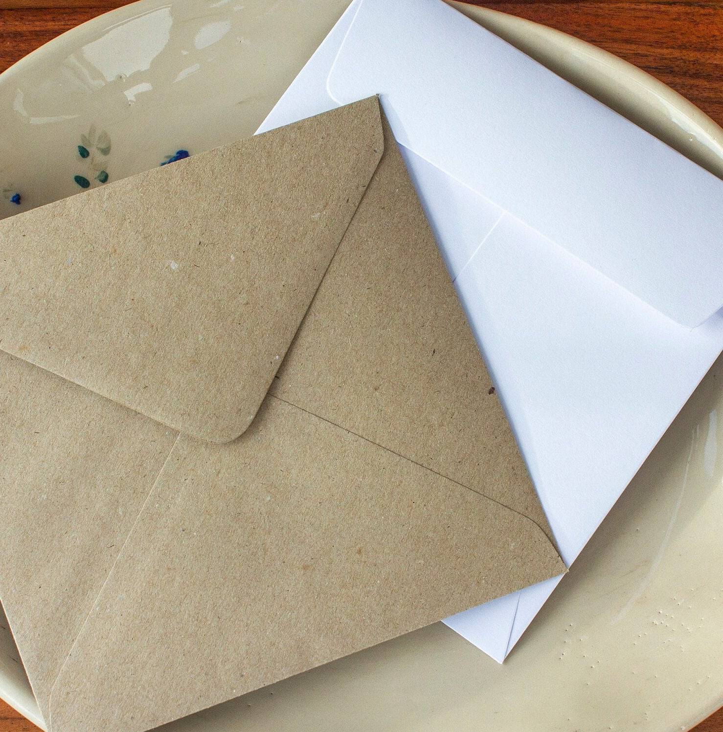 kraft and white envelopes in a dish