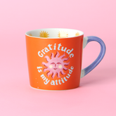 Cheerful new bone china mug with the phrase “Gratitude is My Attitude” and a sun illustration. Comes beautifully boxed in gold foiled packaging.