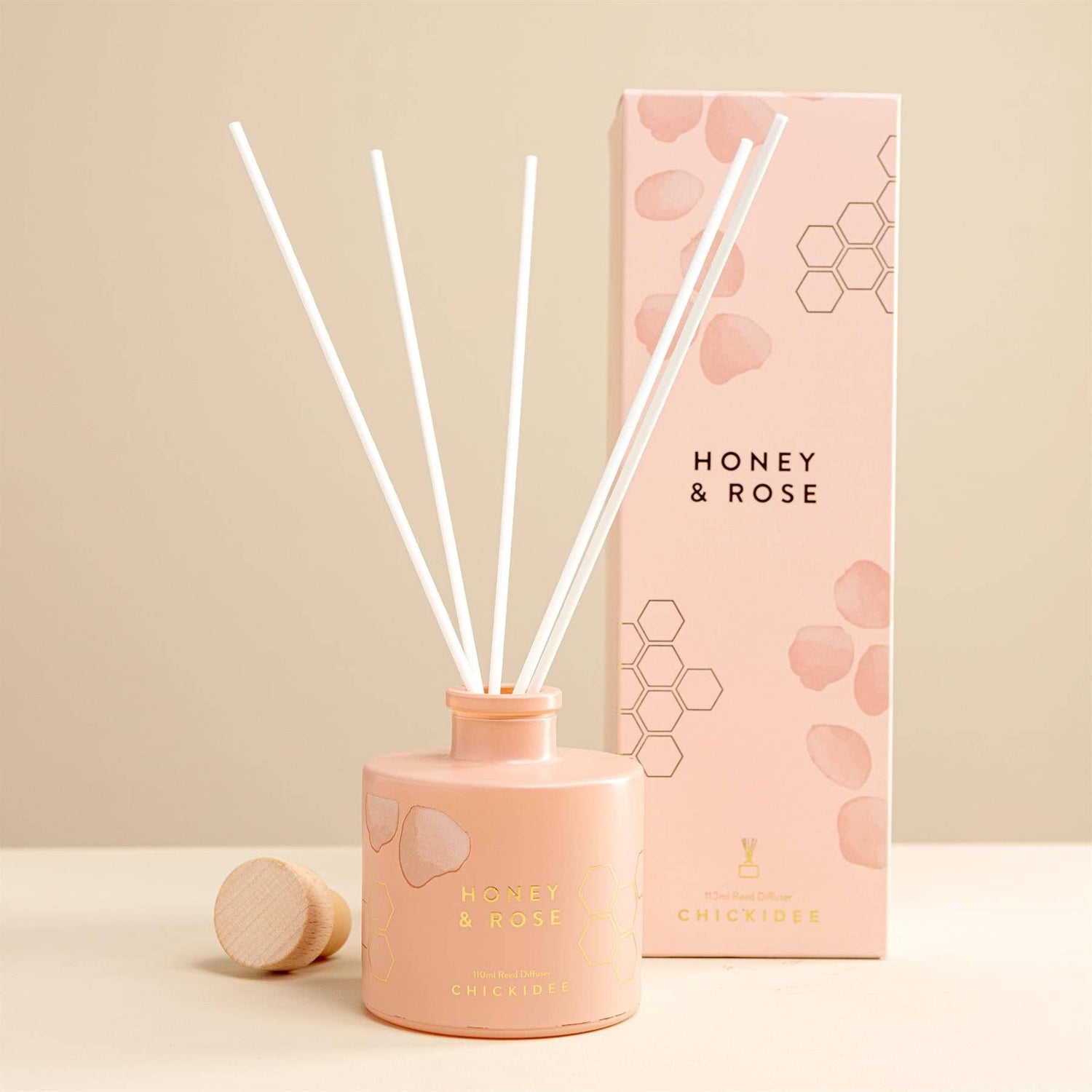 Handcrafted reed diffuser with natural botanicals and premium fragrance oils in a Honey &amp; Rose scent.