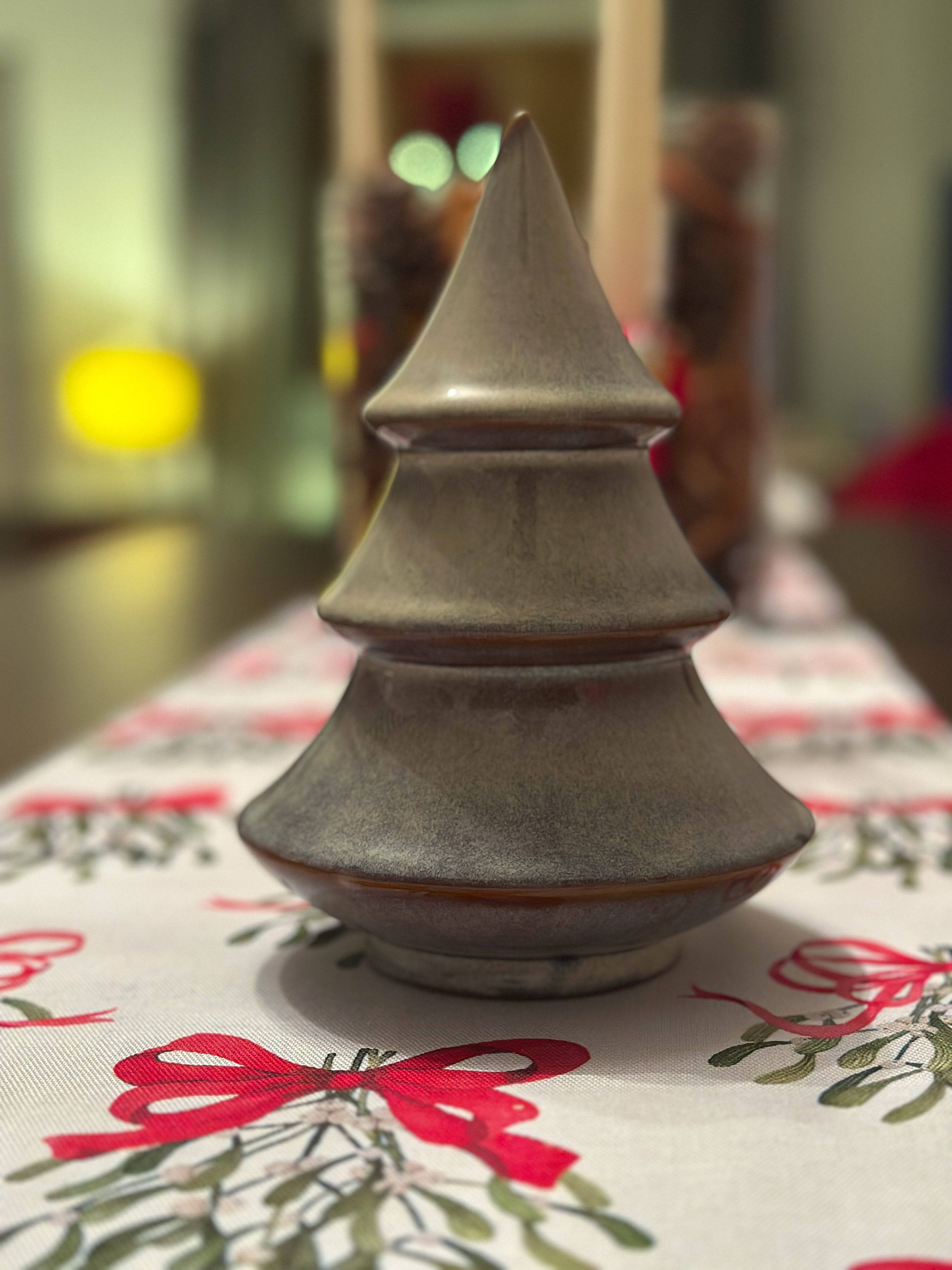 Porcelain Christmas tree ornament with a layered design and reactive glaze. Hand-finished and festive.